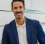 Multiracial business people smiling on camera inside modern office